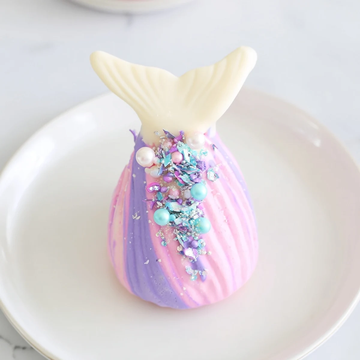 Enjoy colorful Mignardises Queue de Sirène, light and airy madeleines perfect for afternoon tea spreads.