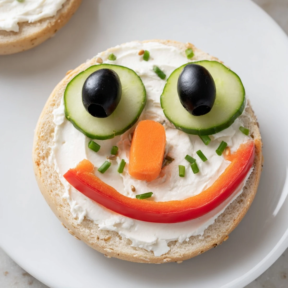 Festive Snowman mini bagel sandwiches featuring cream cheese, perfect for a fun holiday lunch.