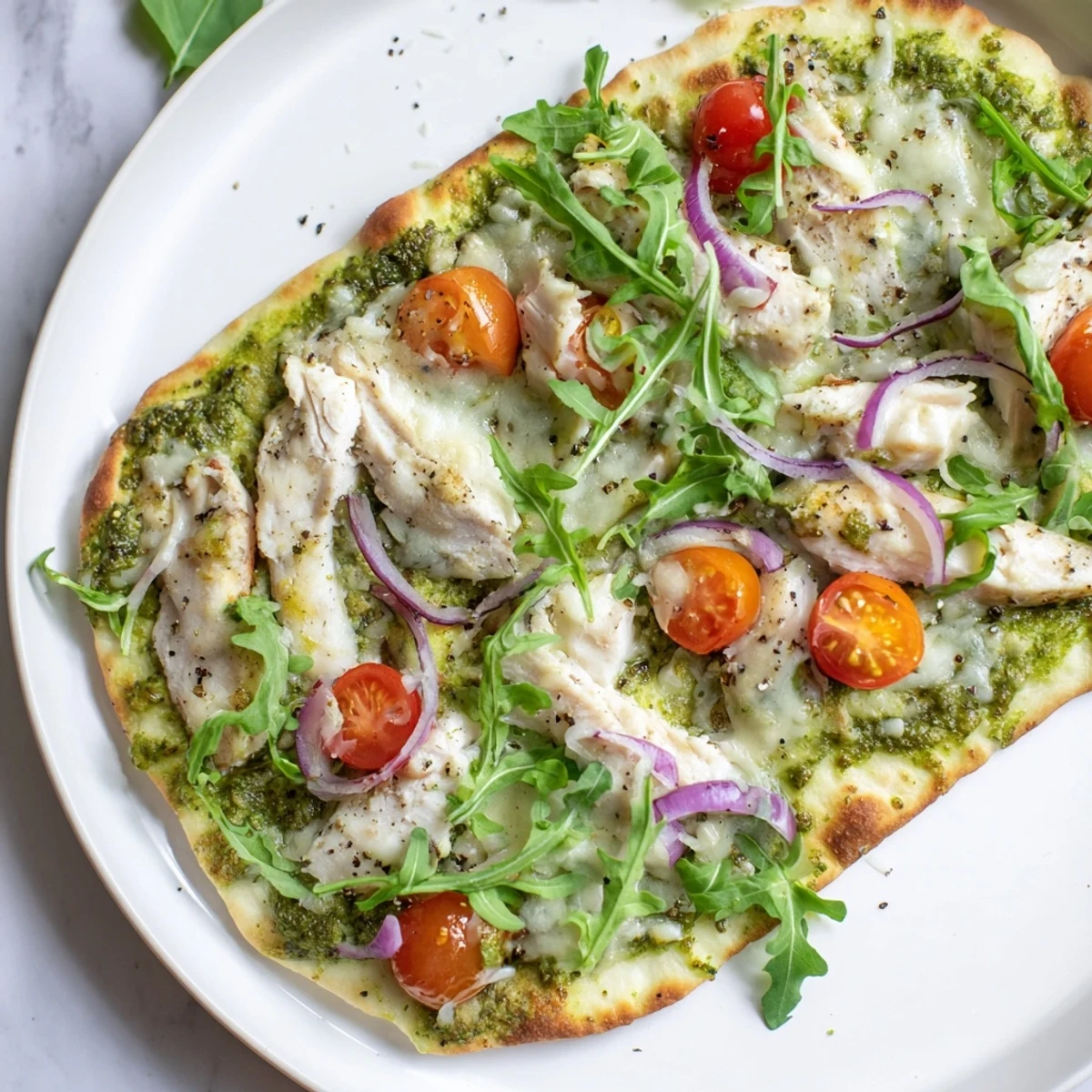 Homemade Pesto Chicken Flatbread, a quick and easy recipe perfect for a weeknight dinner.