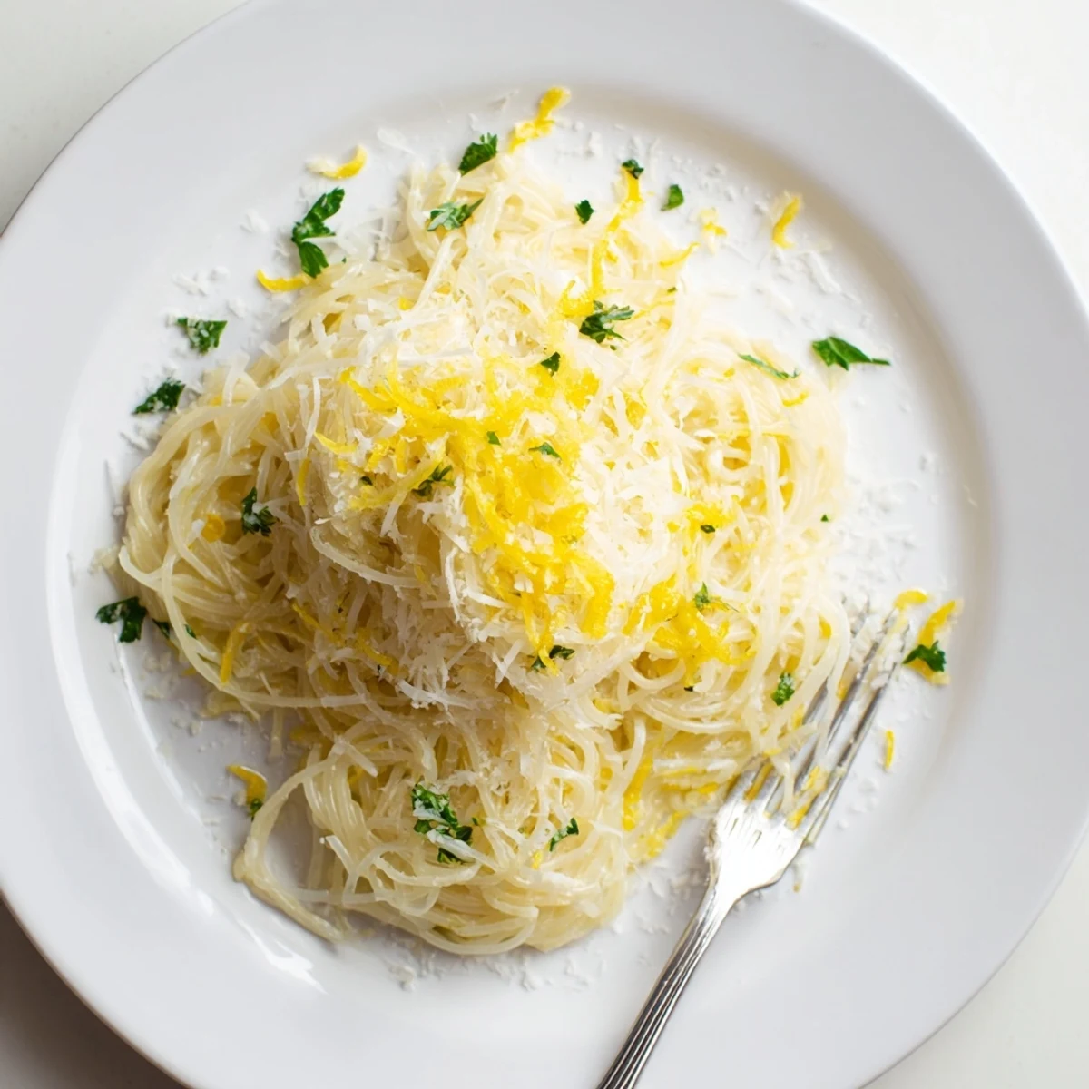 Steamed capellini glistening in a lemon butter sauce, topped with fresh parsley and Parmesan for a light weeknight dinner.