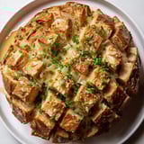 Melting Gruyère covers this flavorful Baked French Onion Dip pull-apart bread, a perfect appetizer.