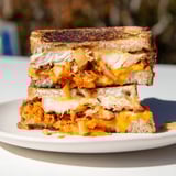 Enjoy a warm and gooey Kimchi Turkey & Cheddar Toasted Grilled Cheese with tangy kimchi filling.