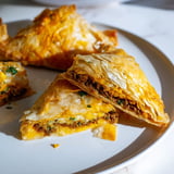 Crispy fried Tunisian Brik, a savory meat-filled appetizer with flaky phyllo dough.