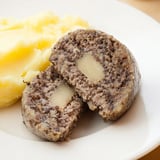 A close-up of a plated Scottish haggis, with fluffy oats and tender meat, ready to enjoy.