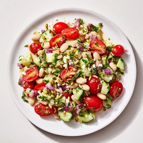 Hearty white bean and lemon salad overflowing with fresh tomatoes and creamy white beans, ready to serve.