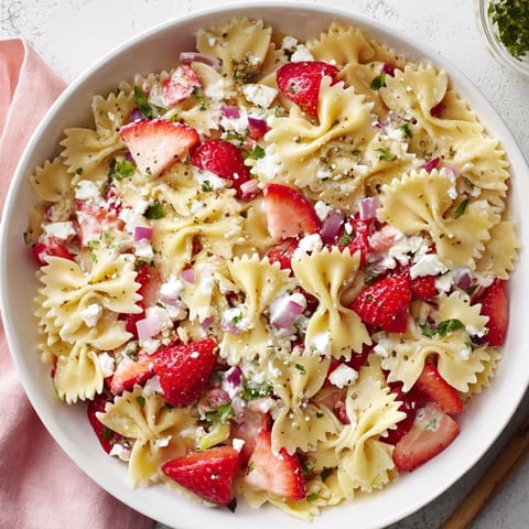 Strawberry Feta Pasta salad, a vibrant mix of berries and creamy feta, ready to enjoy cold.