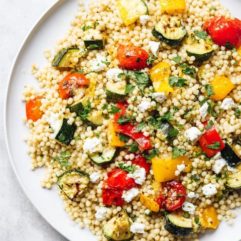 Roasted Veggie Couscous Salad features caramelized zucchini, bell peppers, and red onion tossed with fluffy couscous.