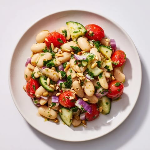 A bright bowl of the fresh Hearty White Bean and Lemon Salad, perfectly seasoned with lemon vinaigrette.