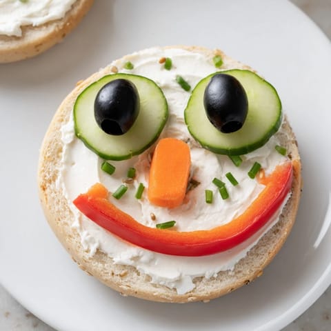 Festive Snowman mini bagel sandwiches featuring cream cheese, perfect for a fun holiday lunch.
