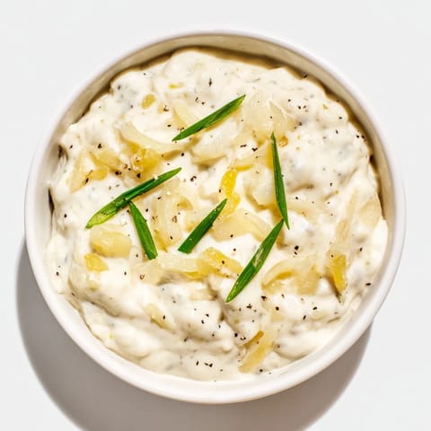 Golden-brown potato chips ready to be dipped into a flavorful onion dip, a classic snack.