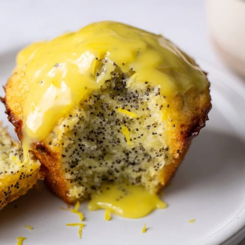 Delicious homemade lemon poppy seed muffins, with visible poppy seeds and a delightful lemon aroma.