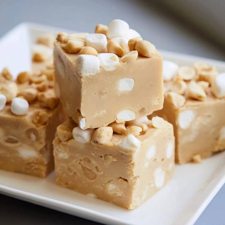 Squares of creamy 5-Minute Peanut Butter Marshmallow Fudge studded with marshmallows, ready for dessert.