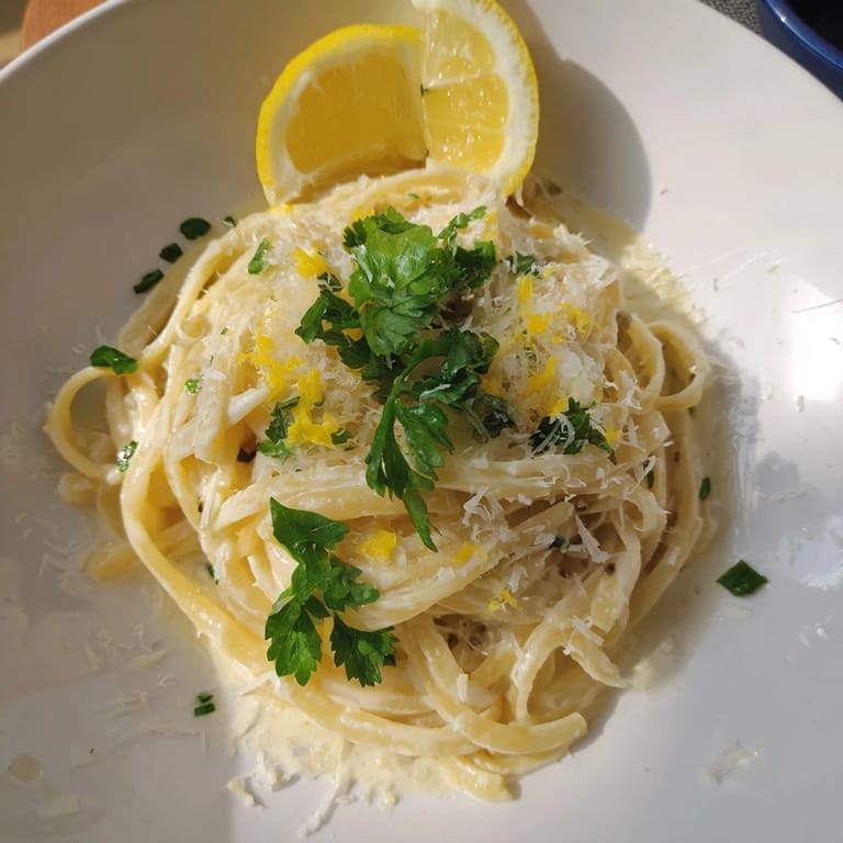 Tangled strands of Lemon-Garlic Greek Yogurt Pasta, coated in a luscious, lemon-infused sauce, delicious.