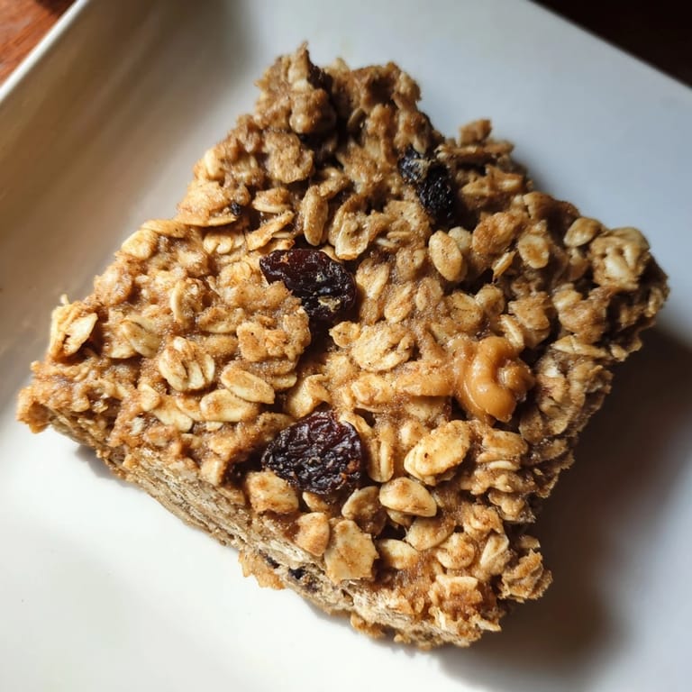 Close-up of baked maple cinnamon oatmeal bars, showing the chewy texture and oat flakes.