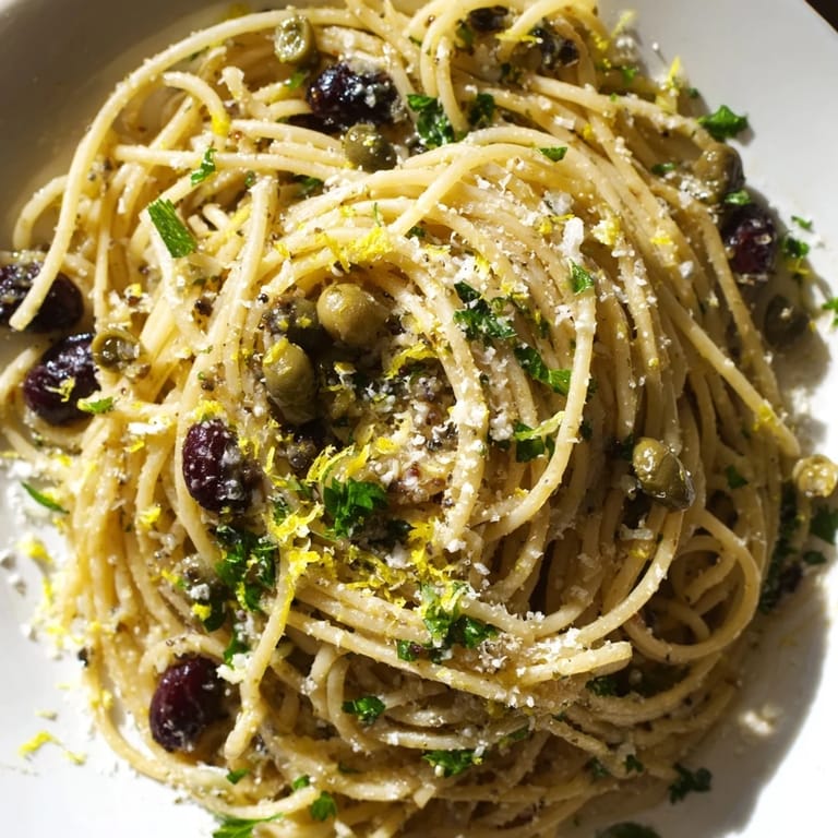 Mediterranean olive tapenade pasta served warm with a drizzle of extra-virgin olive oil and caper-studded sauce.