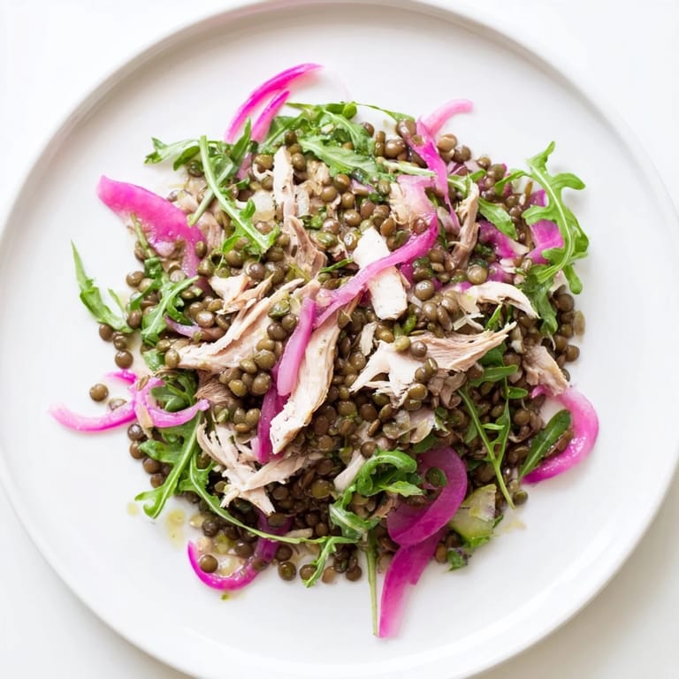 Fork-tender lentils and roasted chicken mingle with arugula and pickled red onions in this fresh Lentil & Chicken Spring Salad.