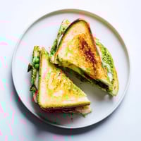 Crispy sourdough slices hold a vibrant spring pea pesto and melted mozzarella in this easy homemade sandwich.  